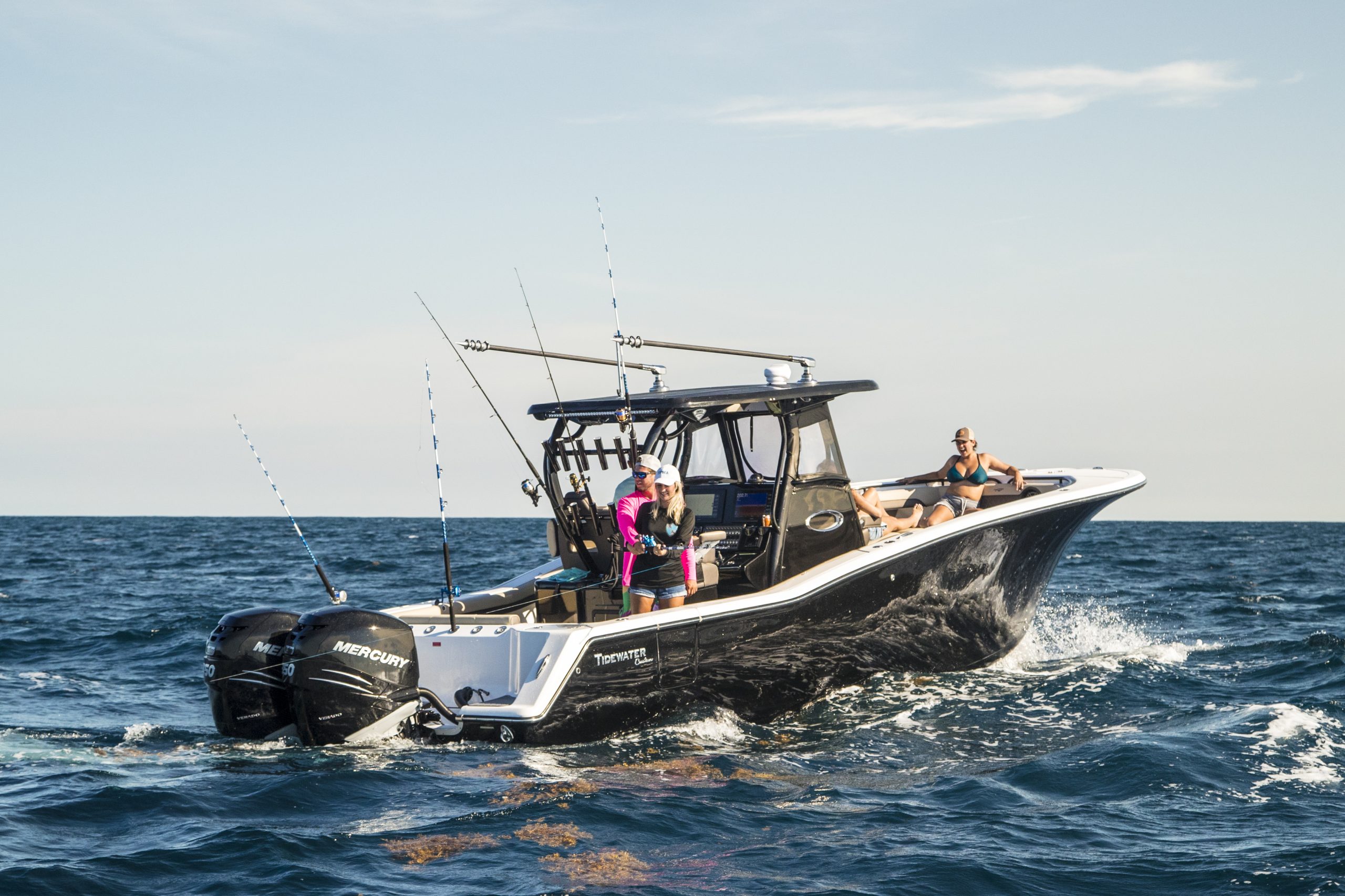 Tidewater boats for sale featuring an offshore center console with twin outboards and family-friendly seating