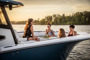 Tidewater boat warranty coverage shown on a Tidewater center console underwaypassengers cruising in calm coastal waters