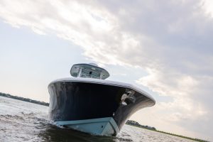 Offshore center console boat cruising on open water at sunrise, sold by Texas Sportfishing Yacht Sales in Texas